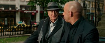 Movie still from “The Last Witch Hunter” (2015), directed by Breck Eisner – A man wearing a hat and a jacket talking to another man; Close Up shot, Over the shoulder angle