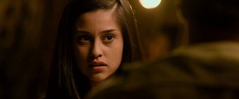 Movie still from “Rambo: Last Blood” (2019), directed by Adrian Grunberg – A young woman's face in the dark; Close Up shot, Over the shoulder angle