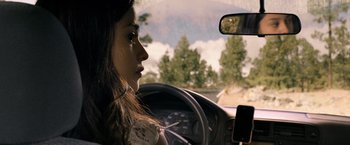 Movie still from “Rambo: Last Blood” (2019), directed by Adrian Grunberg – A woman sitting in the drivers seat of a car looking out the window; Close Up shot, Over the shoulder angle