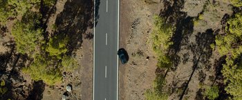 Movie still from “Rambo: Last Blood” (2019), directed by Adrian Grunberg – An aerial view of a car driving down a road; Extreme Wide shot, Overhead angle