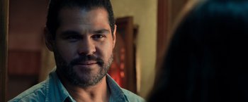 Movie still from “Rambo: Last Blood” (2019), directed by Adrian Grunberg – A person with a beard looking at the camera; Close Up shot, Over the shoulder angle