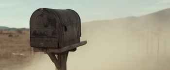 Movie still from “Rambo: Last Blood” (2019), directed by Adrian Grunberg – An old mailbox is sitting on top of a wooden post; Wide shot, Low angle