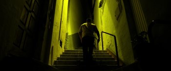 Movie still from “Rambo: Last Blood” (2019), directed by Adrian Grunberg – A man walking down a set of stairs; Wide shot, Low angle