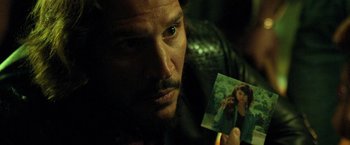 Movie still from “Rambo: Last Blood” (2019), directed by Adrian Grunberg – A person holding up a picture; Close Up shot, Over the shoulder angle