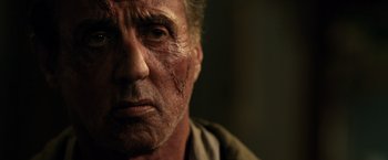 Movie still from “Rambo: Last Blood” (2019), directed by Adrian Grunberg – An older man with a scar on his face; Close Up shot, Low angle