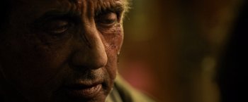 Movie still from “Rambo: Last Blood” (2019), directed by Adrian Grunberg – An old man with a beard and a nose ring looking at the camera; Extreme Close Up shot, Low angle