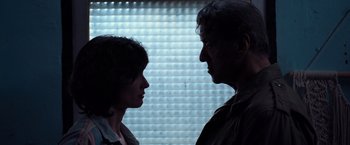 Movie still from “Rambo: Last Blood” (2019), directed by Adrian Grunberg – A man and a woman face to face in front of a window; Close Up shot, Low angle