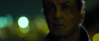 Movie still from “Rambo: Last Blood” (2019), directed by Adrian Grunberg – A man's face with a blurry background; Close Up shot, Low angle