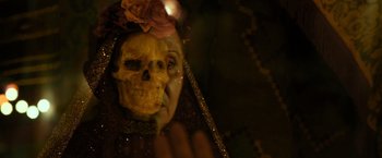 Movie still from “Rambo: Last Blood” (2019), directed by Adrian Grunberg – A skull with a rose on it's head; Close Up shot, Over the shoulder angle