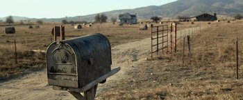 Movie still from “Rambo: Last Blood” (2019), directed by Adrian Grunberg – An open mailbox in the middle of an open field; Extreme Wide shot, High angle