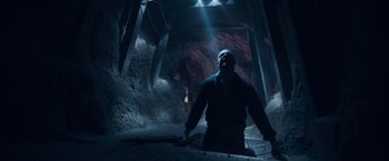 Movie still from “Rambo: Last Blood” (2019), directed by Adrian Grunberg – A man with a mask is standing in a tunnel; Wide shot, Low angle