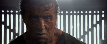 Movie still from “Rambo: Last Blood” (2019), directed by Adrian Grunberg – A man's face in a dark room; Close Up shot, Low angle