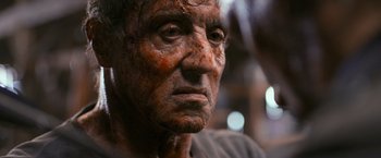 Movie still from “Rambo: Last Blood” (2019), directed by Adrian Grunberg – An old man with a lot of dirt on his face; Close Up shot, Low angle