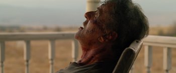 Movie still from “Rambo: Last Blood” (2019), directed by Adrian Grunberg – A person laying on the ground with blood all over his face and neck; Close Up shot, Low angle