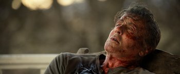 Movie still from “Rambo: Last Blood” (2019), directed by Adrian Grunberg – An older man with blood all over his face; Close Up shot, Low angle