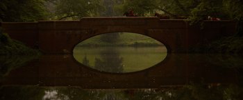 Movie still from “The Last of the Mohicans” (1992), directed by Michael Mann – A view of a lake through a bridge window; Extreme Wide shot, High angle