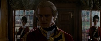 Movie still from “The Last of the Mohicans” (1992), directed by Michael Mann – A person wearing a suit and tie; Close Up shot, Over the shoulder angle