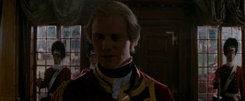 Movie still from “The Last of the Mohicans” (1992), directed by Michael Mann – A man with a long blonde hair and a red and black shirt; Close Up shot, Over the shoulder angle