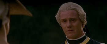 Movie still from “The Last of the Mohicans” (1992), directed by Michael Mann – A person wearing a suit and tie; Close Up shot, Over the shoulder angle