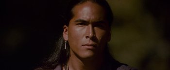 Movie still from “The Last of the Mohicans” (1992), directed by Michael Mann – A person with long black hair; Close Up shot, High angle
