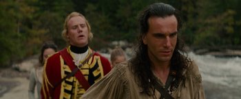 Movie still from “The Last of the Mohicans” (1992), directed by Michael Mann – Two men in medieval garb walking in a line; Close Up shot, Over the shoulder angle