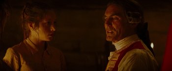 Movie still from “The Last of the Mohicans” (1992), directed by Michael Mann – A man and a woman standing next to each other in front of a brick wall; Close Up shot, Over the shoulder angle