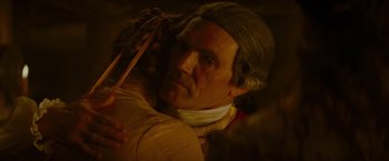 Movie still from “The Last of the Mohicans” (1992), directed by Michael Mann – A person holding a wooden stick; Close Up shot, Over the shoulder angle