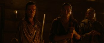 Movie still from “The Last of the Mohicans” (1992), directed by Michael Mann – A couple of men standing next to each other in a room; Close Up shot, Over the shoulder angle