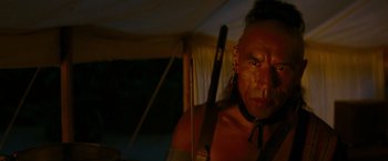 Movie still from “The Last of the Mohicans” (1992), directed by Michael Mann – A man with a bow and arrow in a tent; Close Up shot, Over the shoulder angle