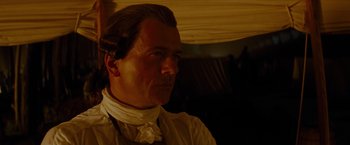 Movie still from “The Last of the Mohicans” (1992), directed by Michael Mann – A person wearing a neck tie; Close Up shot, Low angle