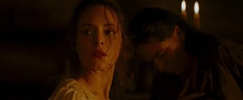 Movie still from “The Last of the Mohicans” (1992), directed by Michael Mann – A young woman is looking at the camera while a young man looks on; Close Up shot, Over the shoulder angle