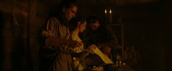 Movie still from “The Last of the Mohicans” (1992), directed by Michael Mann – A group of people standing around a table with papers; Medium shot, Low angle
