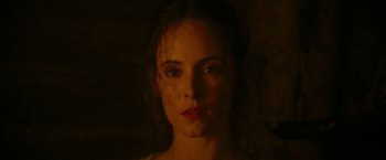 Movie still from “The Last of the Mohicans” (1992), directed by Michael Mann – A person's face in the dark; Close Up shot, Over the shoulder angle