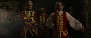 Movie still from “The Last of the Mohicans” (1992), directed by Michael Mann – A group of men dressed in red and yellow uniforms; Medium shot, Low angle