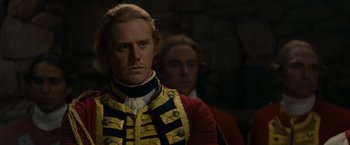 Movie still from “The Last of the Mohicans” (1992), directed by Michael Mann – A man in a red and black jacket and a man in a red and black jacket; Close Up shot, Over the shoulder angle