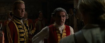 Movie still from “The Last of the Mohicans” (1992), directed by Michael Mann – A man in a red vest and a white shirt; Medium shot, Over the shoulder angle
