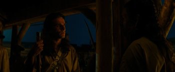 Movie still from “The Last of the Mohicans” (1992), directed by Michael Mann – A man standing in front of a wooden structure; Close Up shot, Over the shoulder angle