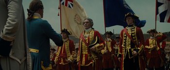 Movie still from “The Last of the Mohicans” (1992), directed by Michael Mann – A group of men in red and gold uniforms; Medium shot, Over the shoulder angle