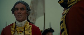 Movie still from “The Last of the Mohicans” (1992), directed by Michael Mann – A man in a red and yellow uniform; Close Up shot, Low angle