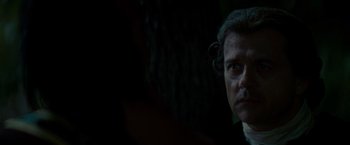 Movie still from “The Last of the Mohicans” (1992), directed by Michael Mann – A person wearing a suit and tie; Close Up shot, Over the shoulder angle