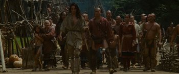 Movie still from “The Last of the Mohicans” (1992), directed by Michael Mann – A group of people walking down a street; Wide shot, Low angle