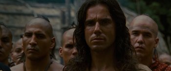 Movie still from “The Last of the Mohicans” (1992), directed by Michael Mann – A person with long black hair; Close Up shot, Over the shoulder angle