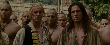 Movie still from “The Last of the Mohicans” (1992), directed by Michael Mann – A group of men standing next to each other in front of a building; Close Up shot, Low angle
