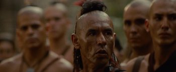 Movie still from “The Last of the Mohicans” (1992), directed by Michael Mann – A person with a mohawk; Close Up shot, Over the shoulder angle