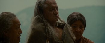 Movie still from “The Last of the Mohicans” (1992), directed by Michael Mann – An older man with long hair and a beard; Close Up shot, Low angle