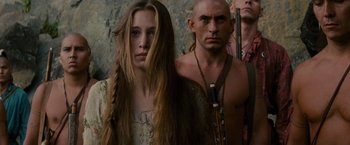 Movie still from “The Last of the Mohicans” (1992), directed by Michael Mann – A man and a woman standing next to each other in front of a stone wall; Close Up shot, Low angle