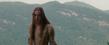Movie still from “The Last of the Mohicans” (1992), directed by Michael Mann – A young woman standing on top of a mountain; Medium shot, Low angle