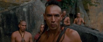 Movie still from “The Last of the Mohicans” (1992), directed by Michael Mann – A person with a bunch of people in the background; Close Up shot, Over the shoulder angle