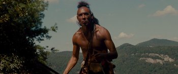 Movie still from “The Last of the Mohicans” (1992), directed by Michael Mann – A man with a long black hair and a long black beard; Medium shot, Low angle
