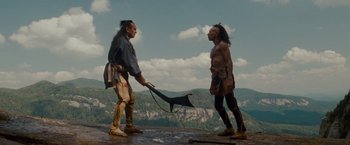 Movie still from “The Last of the Mohicans” (1992), directed by Michael Mann – Two native americans standing on top of a mountain; Wide shot, Low angle